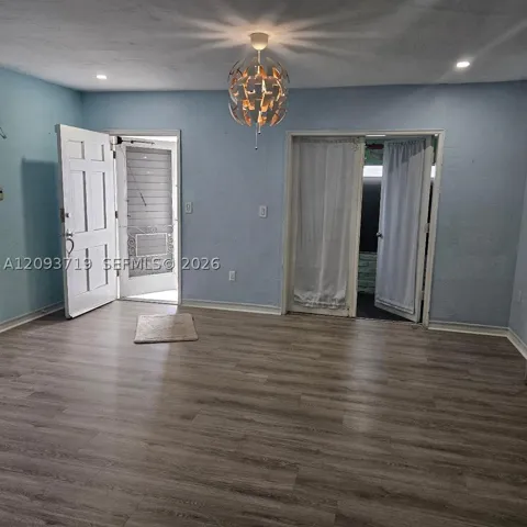 laminate floors in living area-opens to small enclosed porch