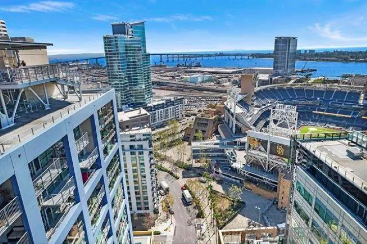 STUNNING SOUTHWEST CORNER TOWNHOME LOCATED IN ONE OF THE MOST SOUGHT AFTER COMPLEX ICON! PETCO PARK AND CITYSCAPE VIEWS! OPEN KITCHEN FLOORPLAN, UPGRADED KITCHEN, STAINLESS STEEL APPLIANCES, GRANITE COUNTERTOPS,FLOOR TO CEILING WINDOWS, GORGEOUS BRAZILIAN HARDWOOD FLOORING THROUGHOUT, 2 EXPANSIVE BALCONIES PERFECT FOR ENTERTAINING-FOLD DOWN BARS INSTALLED. SPACIOUS MASTER BEDROOM,DUAL SINK VANITY IN MB, GUEST BEDROOM HAS DIRECT ACCESS TO SECOND GENEROUSLY SIZED BALCONY & DIRECT FULL BATHROOM ACCESS. STORAGE UNDERNEATH STAIRS, STORAGE LOCKER INCL. FURNITURE INCL IN SALE. ICON OFFERS INCREDIBLE AMENITIES 26TH FLOOR ROOFTOP VIEWS INSIDE PETCO PARK, WATER, CORONADO BAY/ISLAND OCEAN VIEWS, 1700 SQ.FT STATE OF THE ART FITNESS CENTER, THEATER ROOM, 5TH INNING LOUNGE CLUBHOUSE, LUSH/ZEN INTERIOR COURTYARD. ICON COMPLEX MAY QUALIFY UNDER THE MILLS ACT- REDUCED PROPERTY TAXES. WIFI INCLUDED IN HOA DUES.
