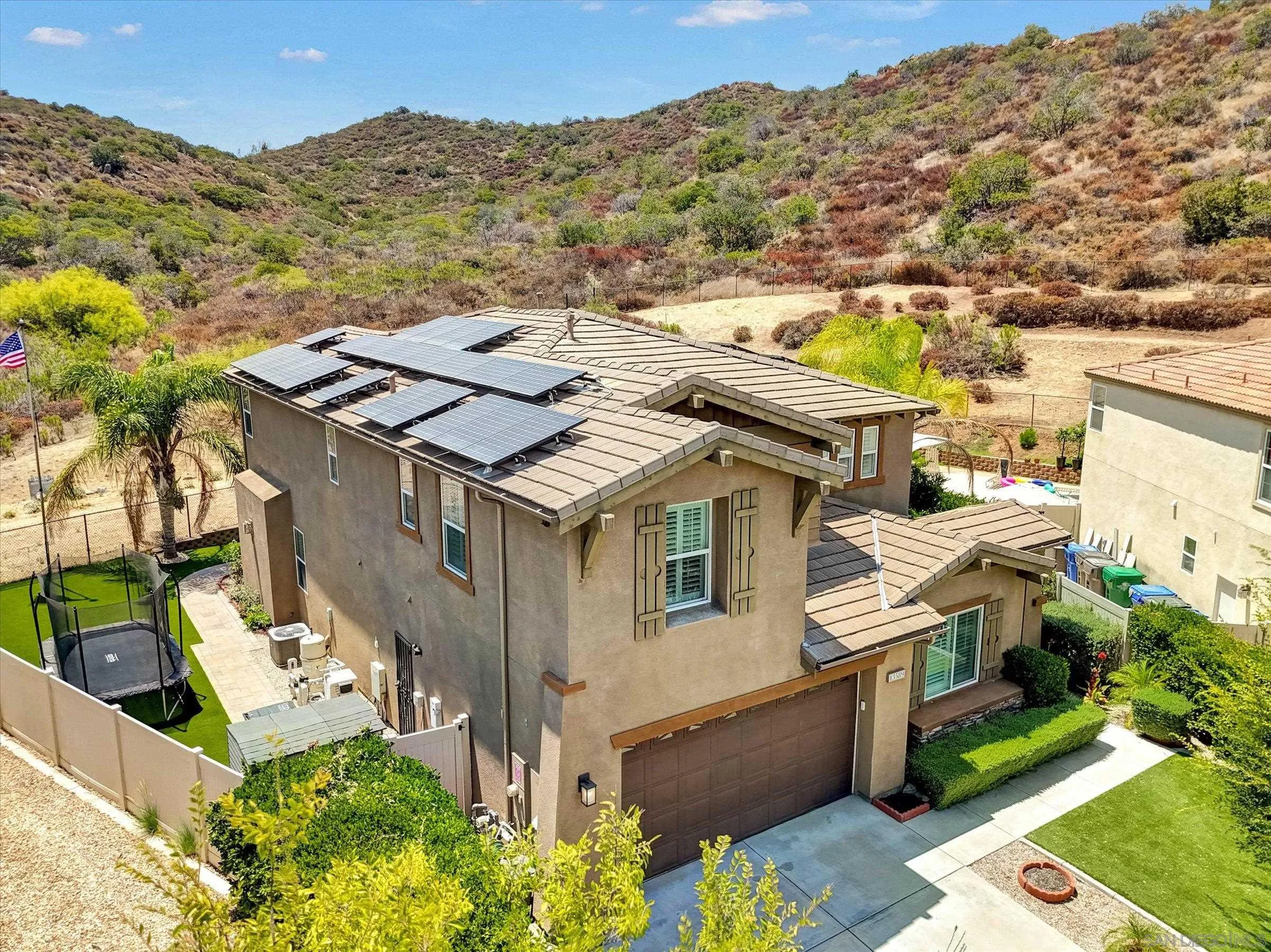 Situated at the end of a peaceful cul-de-sac, this extraordinary estate  offers an unparalleled blend of luxury, comfort, and California outdoor living. Set on approximately half an acre, this exceptional property seamlessly combines modern elegance with resort-style amenities to create a private retreat you'll never want to leave. Leased Solar System: Enjoy energy-efficient living with 40 leased solar panels, helping to reduce energy costs Outdoor Paradise Discover private hiking trails that wind behind the property, leading to breathtaking views and peaceful natural surroundings. Relax or entertain in the stunning saltwater pool and spa, finished with a luxurious PebbleTec® surface. Covered Gas Fire Pit: Gather w/ family & friends beneath the stars around the inviting covered gas fire pit, creating the perfect setting for year-round outdoor enjoyment. Exceptional Outdoor Living. The expansive Ramada features a fully equipped outdoor kitchen complete with a built-in BBQ, refrigerator, wet bar sink, serving bar, Two televisions, and custom lighting ideal for effortless entertaining. Beautifully Upgraded Interior. Thoughtfully designed living space, this home has been meticulously upgraded throughout. Features include custom engineered hardwood &porcelain tile flooring, upgraded stair railings, elegant granite and natural stone countertops, premium cabinetry, and high-end finishes in the kitchen and bathrooms. Nearly every builder upgrade.
