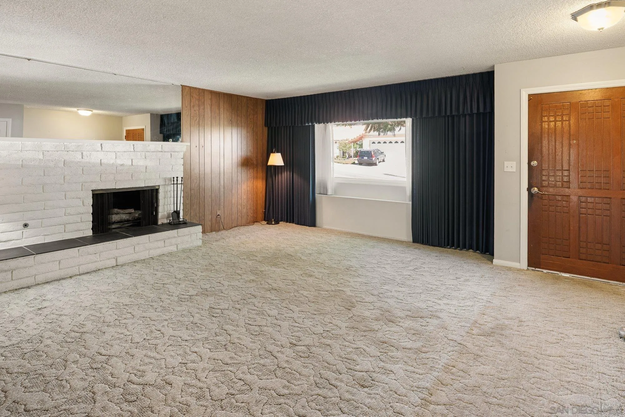 6010 Chadwick Ave, San Diego, CA 92139 Large living room with gas fire place . Custom entry door.