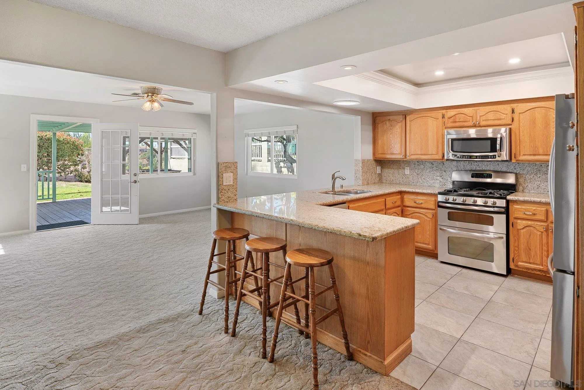 6010 Chadwick Ave, San Diego, CA 92139 Large kitchen with newer appliances. Open concept to the family room. And then access to the backyard deck.