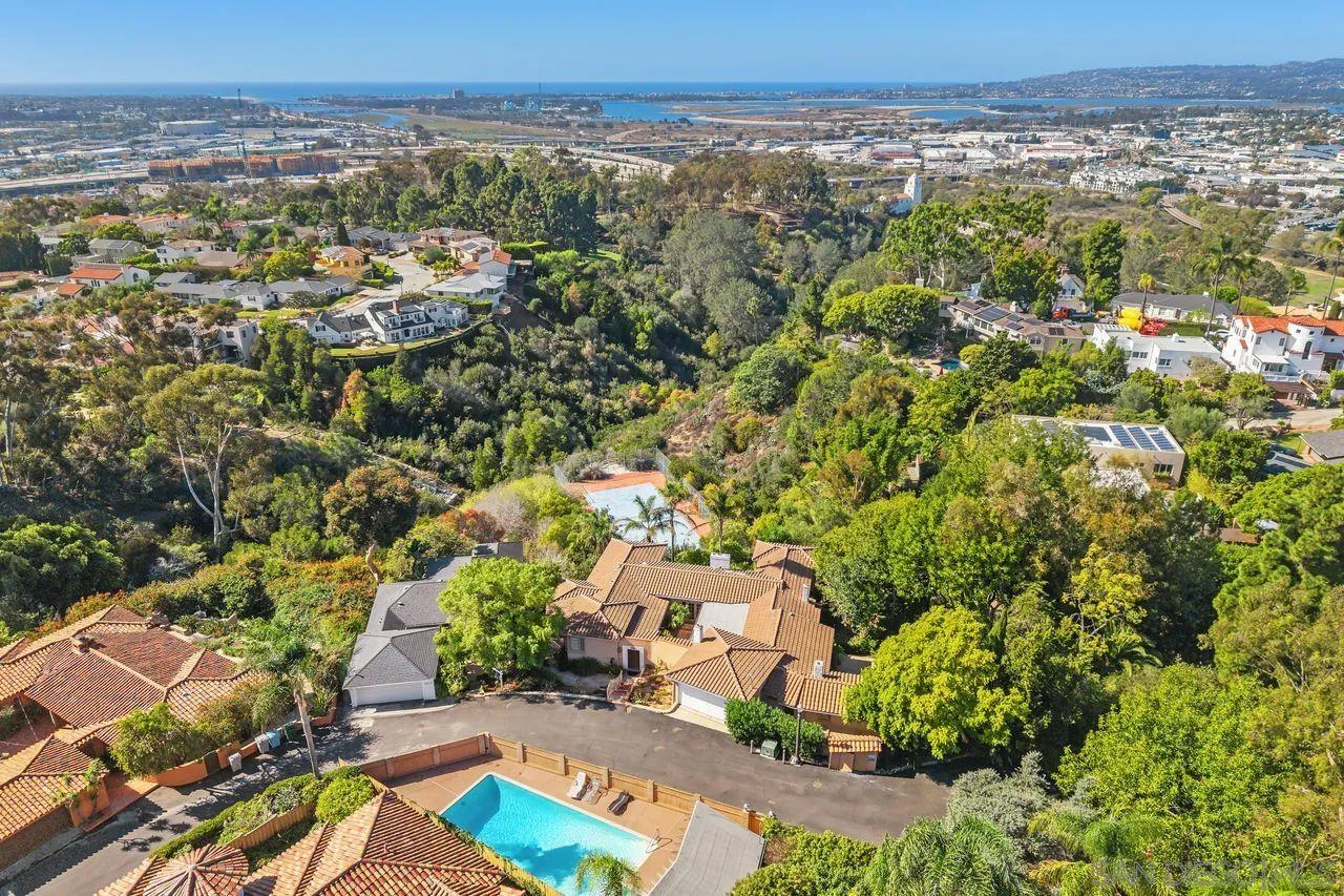 This exceptional Mission Hills estate—held privately for nearly six decades—offers a compelling opportunity to own a true legacy property in one of the area’s most prestigious and historically rich enclaves. Evoking the romance of classic Spanish architecture, this distinguished residence blends timeless elegance with the glamour of years gone by. Set across 3 parcels totaling more than 1 acre, the property commands sweeping views over Presidio open space, extending to captivating cityscapes and glistening water vistas. Tucked away on a cul-de-sac, the property delivers a sense of seclusion and tranquility—evoking the ambiance of a private retreat, yet moments from the best the city has to offer. The main level is thoughtfully designed with 4 spacious bedrooms and 4 bathrooms, anchored by an inviting courtyard entrance and an inspiring kitchen that overlooks a lovely, private garden. Designed with both intimacy and flexibility in mind, the lower level offers a fully equipped guest retreat with 2 bedrooms, 2 baths, a kitchenette, generous living space, and abundant storage—perfect for extended stays or seamless integration into the main home. The grounds are enchanting, with meandering pathways leading to a vintage tennis court and a charming pony stable—a nod to the property’s rich heritage and pastoral past. Every element of this estate tells a story. For those seeking an even more expansive vision, the adjacent residence at 2417 Arista Court is also available, presenting a truly exceptional opportunity to create a landmark compound of remarkable scale and distinction.