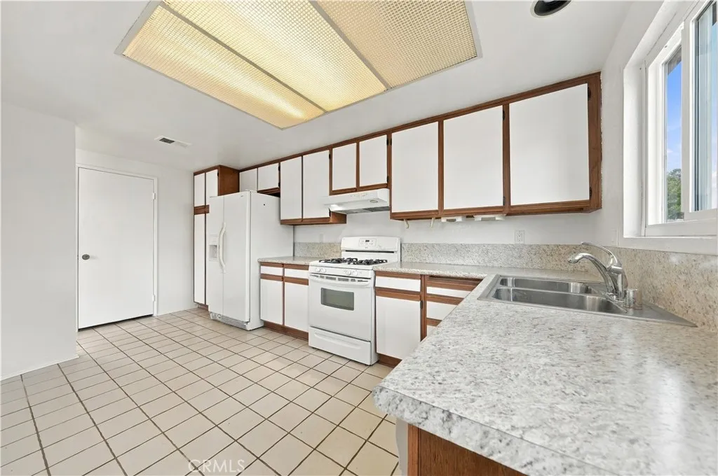 Reverse view of kitchen. door at left is pantry storage area.