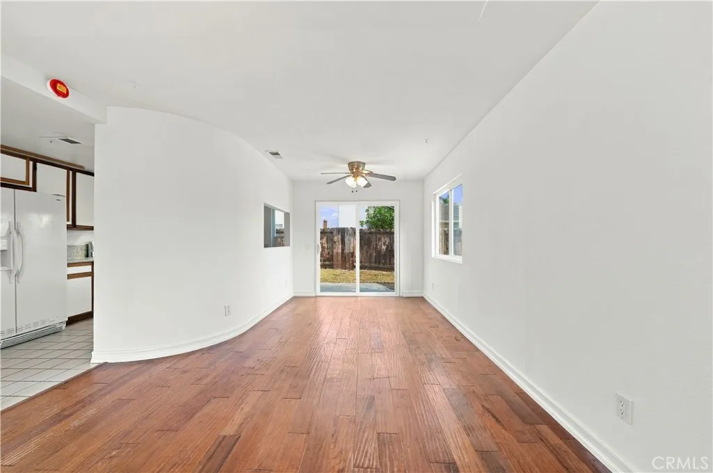 Dining area w ceiling fan/light fixture and dual pane slider to rear yard and patio