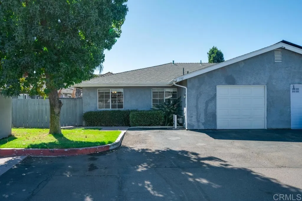 Single car garage. Two parking spaces-one in front, and one to the left of garage near tree.