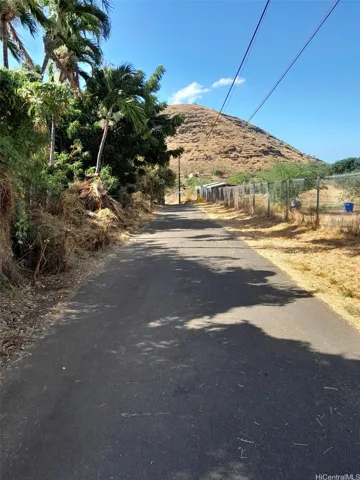 Long wide driveway down into the property