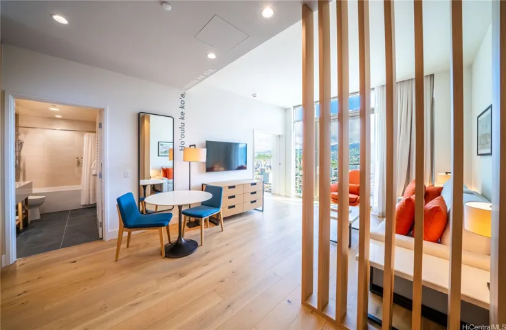 The living room has decorative wooden slates to give a little privacy.

