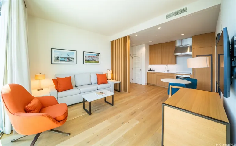 A beautiful hardwood floor with Wolf and Sub-Zero appliances in the kitchen