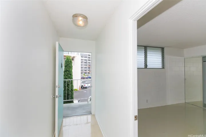 View to front door and through bedroom door