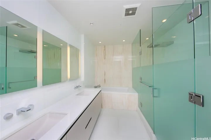 Main bath with shower and toilet located behind the glass doors.