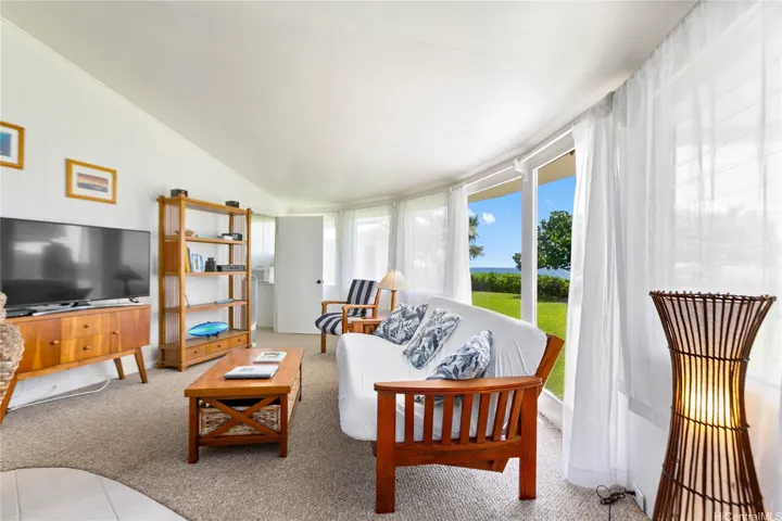 Enjoy your sunlit cottage living room with gentle, cool breezes flowing off the Makaha beachfront. Relax in comfort while soaking in the natural beauty and peaceful island atmosphere.