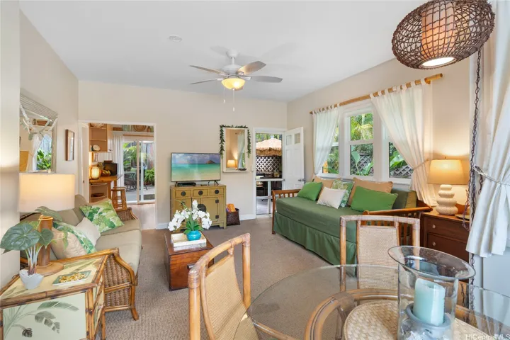 Front entry door to the right, on the left the kitchen flows to outdoor lanai space..