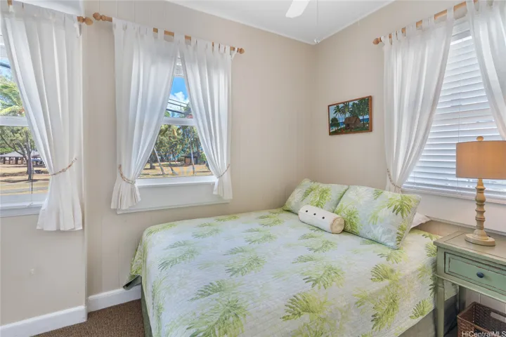 Bedroom 1 enjoys views across green space of Kailua Beach Park.