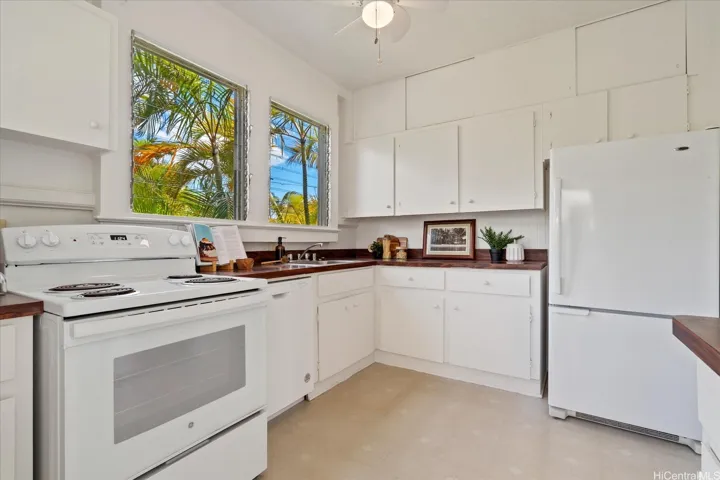 Fabulous windows over the kitchen sink; note the additional storage cubbies above the upper cabinets