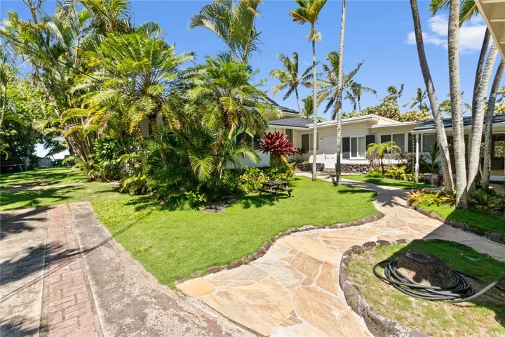 The large, open entry area invites refreshing coastal breezes and offers extra parking and open space, combining practicality with island-style living. North Shore Haleiwa Hawaii.