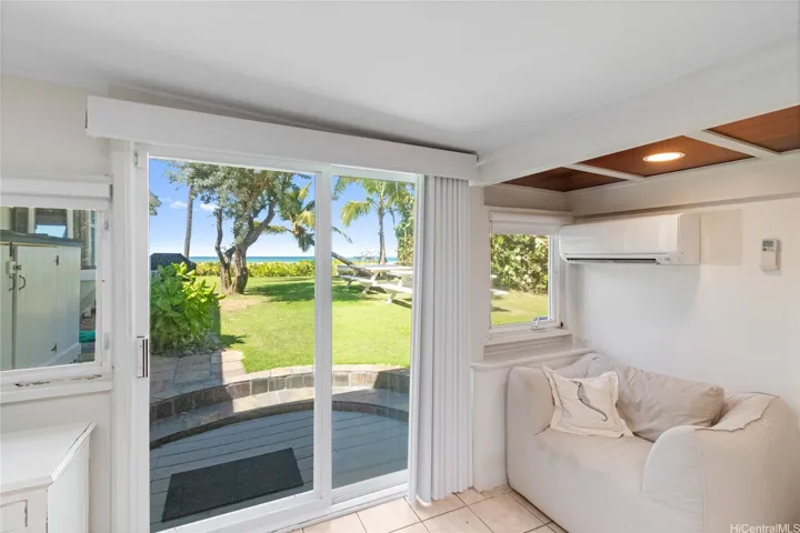 The ocean-view ensuite third bedroom features private side yard access, combining comfort and convenience with picturesque surroundings. North Shore Haleiwa Hawaii.