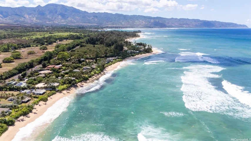 Imagine starting your day with a peaceful one-mile walk along pristine white sand, leading you straight into the heart of Haleiwa for a fresh coffee or a local breakfast favorite. Nearly half of this serene path borders untouched tropical forest, part of the scenic land owned by Kamehameha Schools—meaning no homes, just the sounds of nature and ocean breeze. It's not just a walk... it's a lifestyle.North Shore Haleiwa Hawaii.
