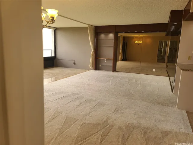 Living room with upgraded tinted mirrors and bookshelf