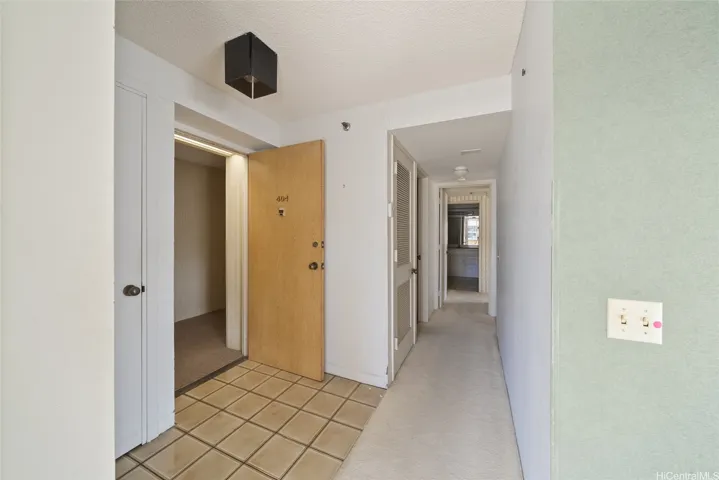 At the Entryway, Second Bedroom behind. Forward to access both bathrooms and the Master Bedroom