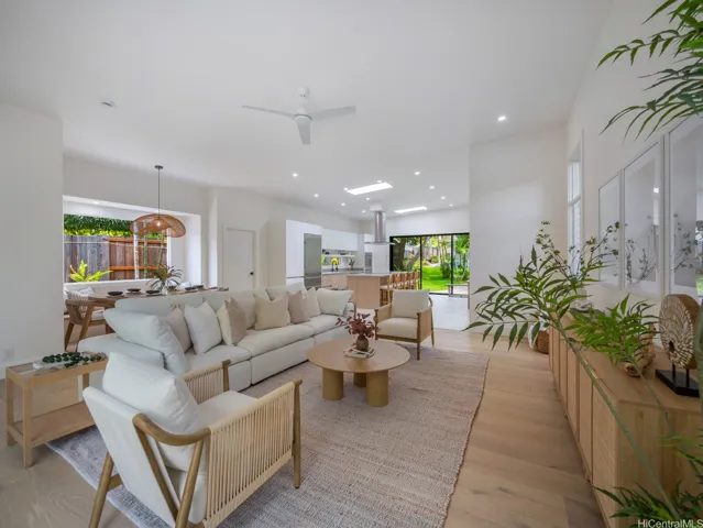 Bright and airy living spaces feature light hardwood floors, soaring ceilings, skylights and oversized sliding doors that open to the lanai. A combination of oversized sliding doors, new 6" jalousie windows plus split AC throughout offers year-round comfort.