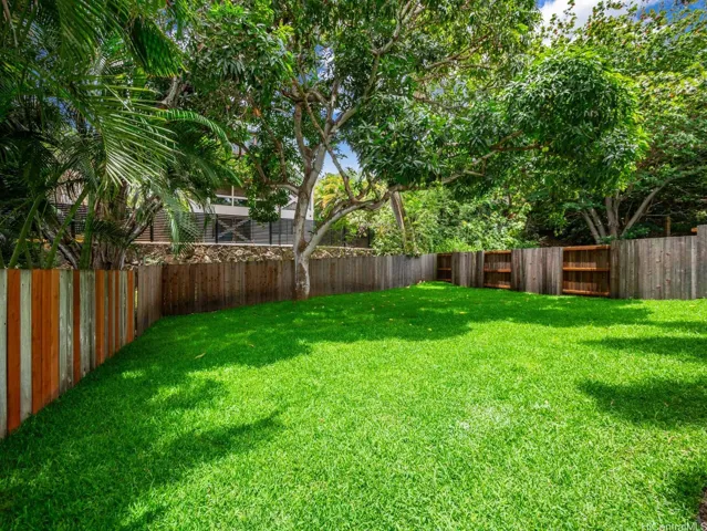 The expansive backyard features a brand-new, beautifully manicured lawn and a mature, fruit-bearing mango tree—offering the perfect setting for play, relaxation, or outdoor entertaining. There is ample space for a large pool!