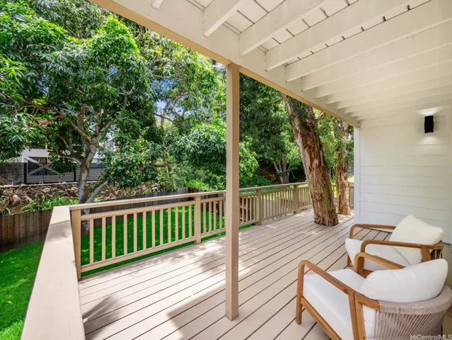 he downstairs bedroom lanai offers additional outdoor living space and easy access to the expansive backyard. In keeping with the home’s nature-focused design, two mature eucalyptus trees were thoughtfully integrated into the lanai—blurring the line between architecture and the landscape.