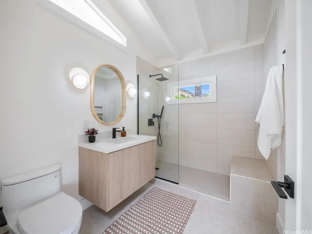 The spacious bathroom in the 1-bed, 1-bath suite features high ceilings and ample natural light, creating a bright and airy atmosphere that enhances its sense of comfort and retreat.