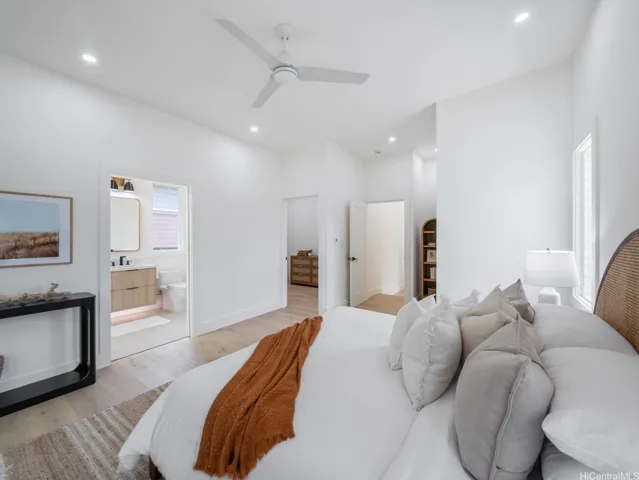 This main level primary suite is a true retreat, featuring high ceilings, abundant natural light, and a seamless connection to a private lanai. The spa-like ensuite bath offers a luxurious escape, while the large walk-in closet provides ample space and customization potential (choose from a selection of professionally designed closets to be installed by closing or personalize your own closet)—combining comfort, serenity, and functionality in one beautifully designed space.