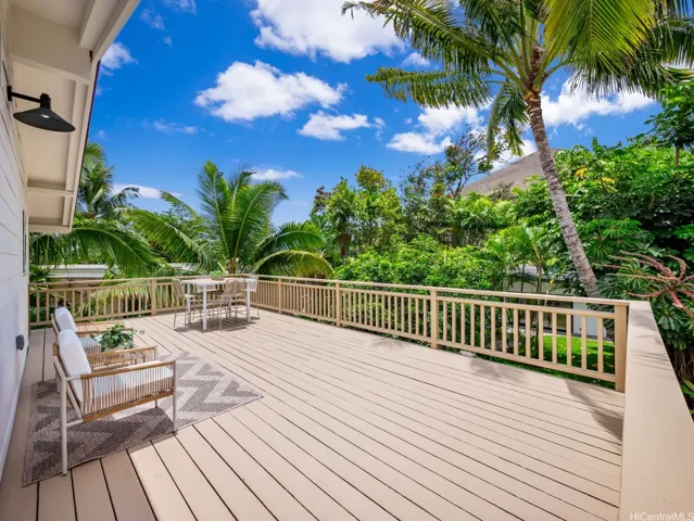 The 1-bed, 1-bath suite above the garage features a spacious private lanai at the rear—perfect for lounging, outdoor dining, or a peaceful morning yoga session surrounded by tropical greenery.