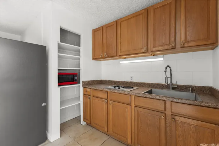 Built-in shelving provides extra storage next to the kitchen workspace.