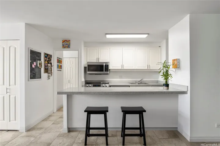 Virtually staged. Renovated full kitchen, including dishwasher.
