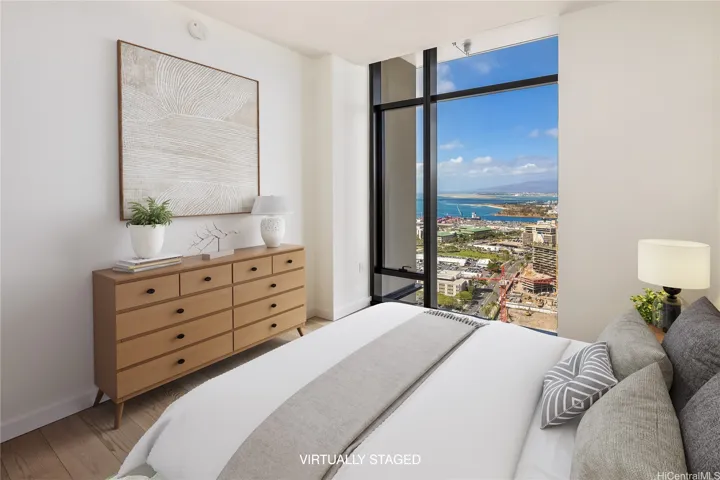 The bedroom (Virtually Staged) also has the soaring ceilings and ocean views.