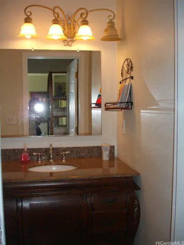 Downstairs Full bedroom with granite top and wooden vanity