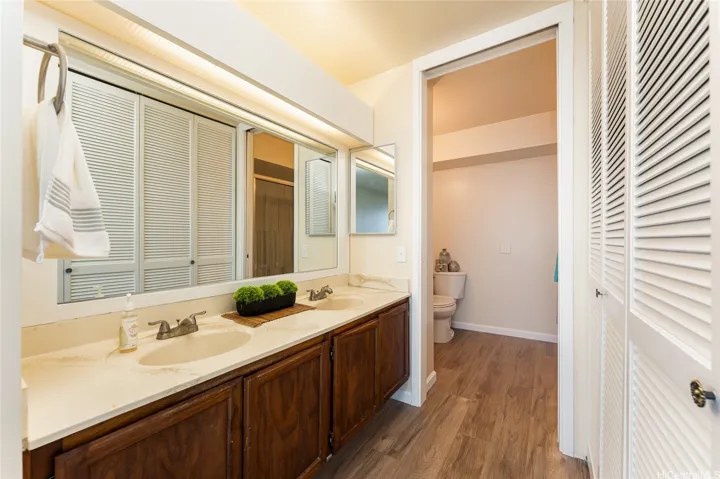 Primary bathroom w/two sinks and closets.