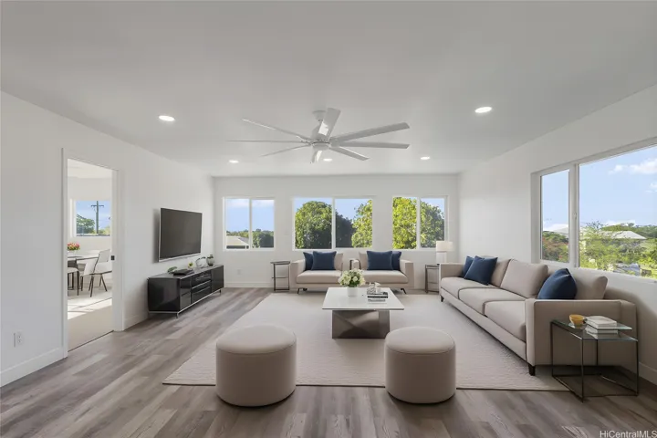Enhanced photo of upstairs living room staged with virtual furniture. Peek-a-boo ocean views from these windows.