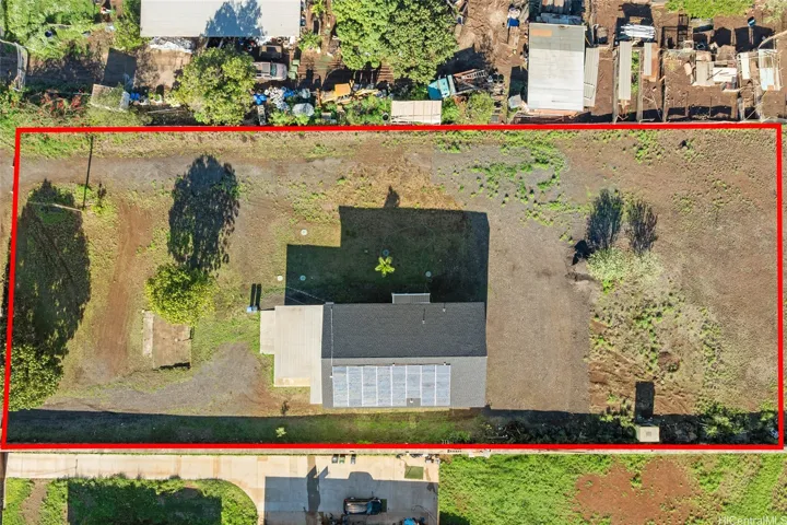 Aerial view of the roof top with solar panels. Red line does not take the place of an actual survey.