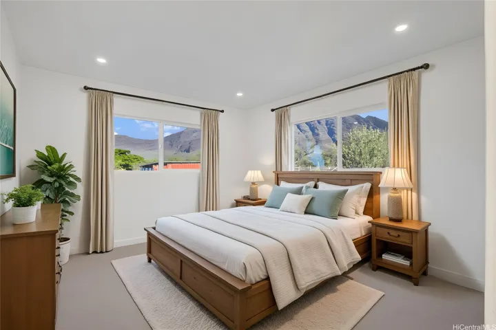 Enhanced photo of downstairs bedroom with virtual staging. Note the mountain views.