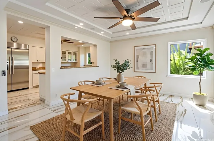 Dining area open to kitchen with backyard views. Enhanced.