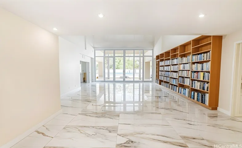 Entryway with marble-like flooring and built-in shelving. Enhanced.