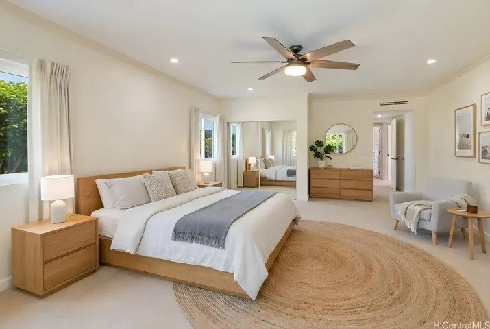 Primary bedroom with private lanai access. Enhanced.