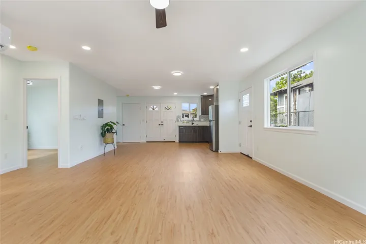 Downstairs view from the living room towards main entrance and wet bar