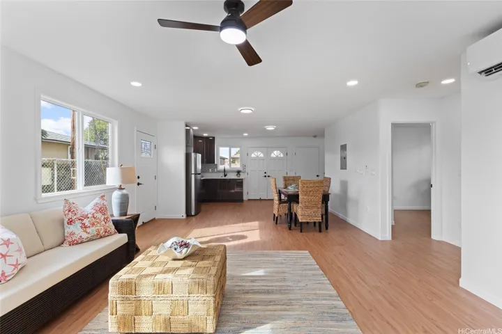 View of living room toward dining room, wet bar and main entrance downstairs