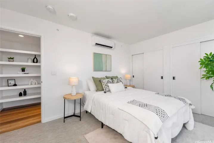 Serene bedroom featuring built-in shelving, generous closet storage, and a clean contemporary design