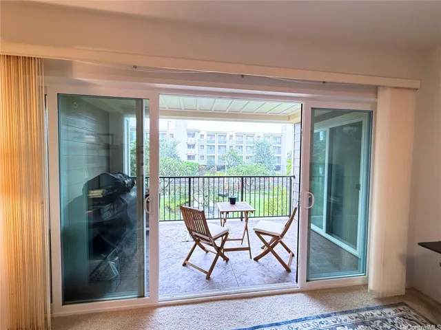 Enhanced - Lanai accessible through living room and primary bedroom. Views of courtyard, Aoloa Street, & Building 6.