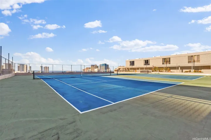 Tennis courts with view of city skyline