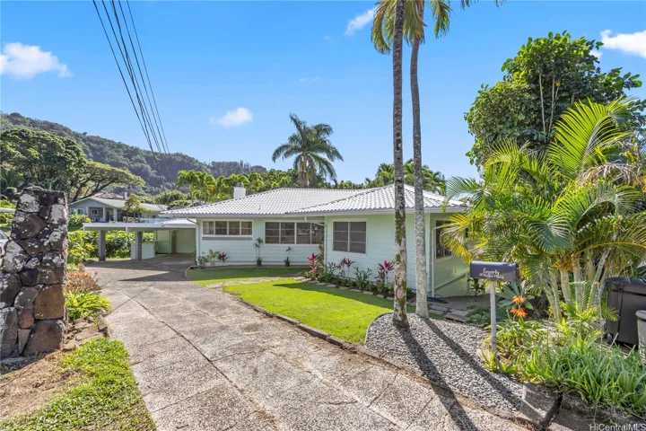 Front exterior of home with landscaped yard and driveway entry