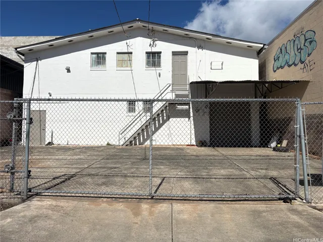 Exterior of warehouse bldg, 2nd floor opening, rollup door and loading & parking