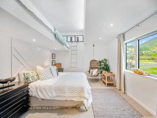 This charming bedroom features an upper loft area.
