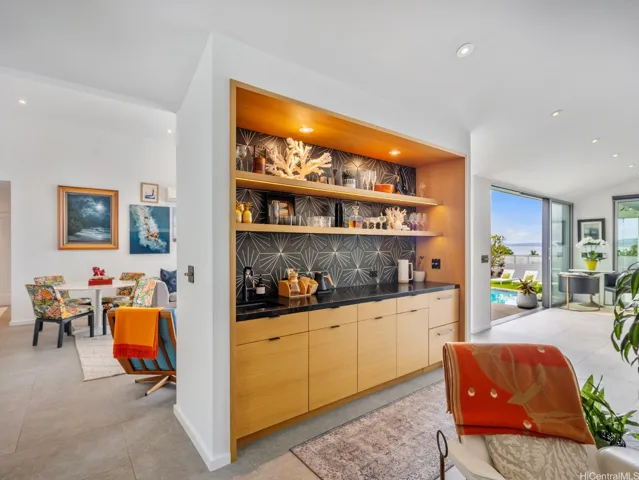A well-appointed beverage bar featuring pull-out dishwasher drawers and a dedicated sink area.
