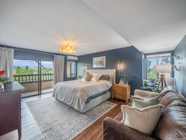 Private primary bedroom with tree top views of the Koolau mountain range.